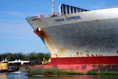 Container ship passing city dock